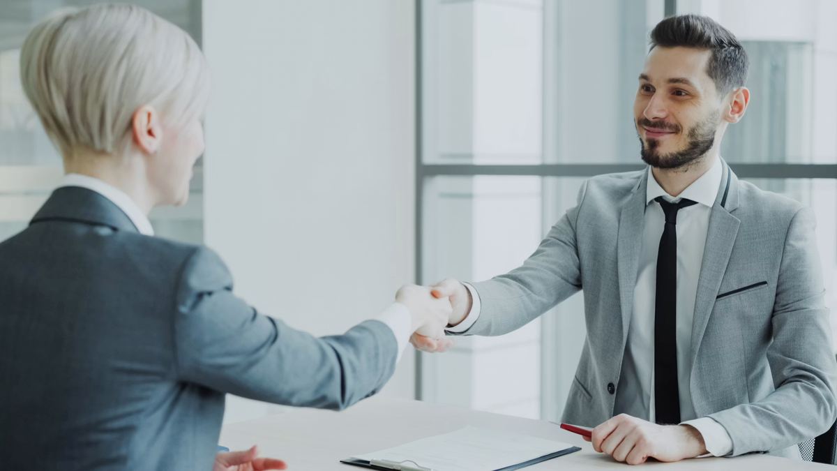 An employer and a new hire shaking hands